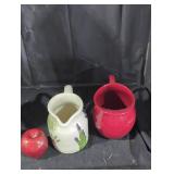 A red metal and a ceramic pitcher lot.