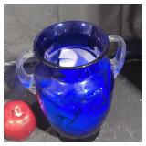 Blue glass vase with clear glass handles.