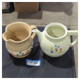 A ceramic pitcher and porcelain pitcher lot.