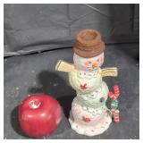 Glazed over ceramic snowman figurine.