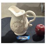 Ceramic pitcher with deer design.