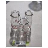 Trio of vintage milk bottles.