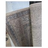 Rolled up brown,tan, blue area rug(63in width)