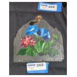 Hand painted flowers on flat rock.