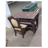 Vintage desk on wheels and chair.