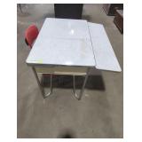 Metal table with red metal chair.