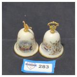 Pair of porcelain bells with gold colored trim.