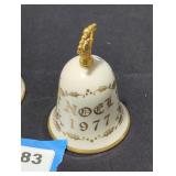 Pair of porcelain bells with gold colored trim.