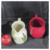 A red metal and a ceramic pitcher lot.