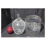 Glass vase with metal netting.