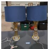 Pair of table lamps blue shades with brass bases.