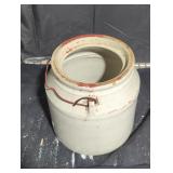 Stoneware jar with handle and no lid.