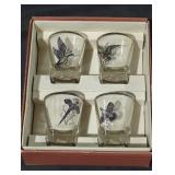4 shot glasses with different animals on them.