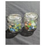 Two jars filled with marbles.