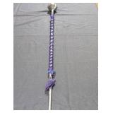 Aluminum cane with rope tied around it.
