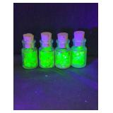4 small glass jars with Uranium glass inside of