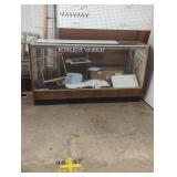 Display case with items inside and on top