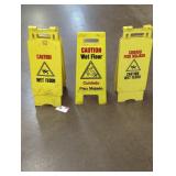 Trio of caution wet floor signs