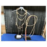 RAWHIDE HEADSTALL W/THROAT LATCH AND ROMAL REINS.
