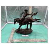 STATUE OF COWBOY RIDING A BUCKING HORSE
