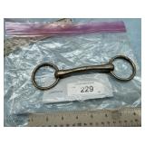 LOOSE RING SNAFFLE HORSE BIT WITH A CURVE.