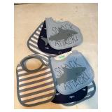Seven blue bibs for babies