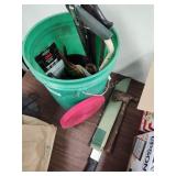 Pail with saws, machete and other