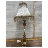 Brass color table lamp with fringed mirror