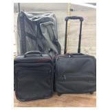 Grey large duffel bag style suitcase and 2 small