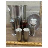 metal trash can and salt and pepper grinders