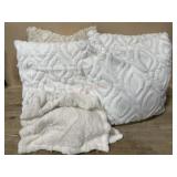 Box with white throw pillows and tan pillow and
