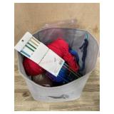 Basket of yarn and knitting needles
