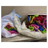 Box of grass skirts and plastic leis