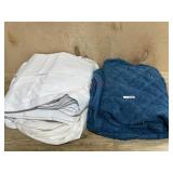 White blackout curtains and blue blanket