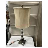 Glass and metal table lamp with tan shade