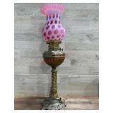 Brass banquet lamp with Fenton cranberry coin