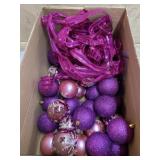 Box of purple and pink ornaments and ribbon