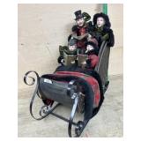 Carolers in wood and metal sleigh