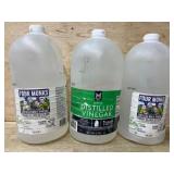 Three Gallon-Sized Vinegar Bottles