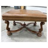 Wood carved and leather upholstered bench with