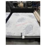 King size bed with tufted black headboard and