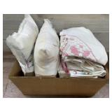 Box with embroidered pillow cases and throw