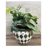 Green and white ceramic pot with greenery