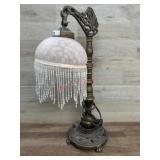Bronze color table lamp with beaded shade