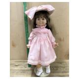 18 inc vinyl doll in pink dress with stand