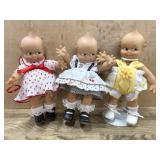 3- Kewpie Dolls and one stand