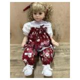 Royal Vienna 23 inch vinyl doll in red flioral