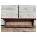 Red wooden rack w/ pegs