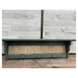 Green wooden shelf w/ pegs