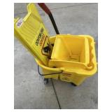 Mop bucket and wet floor sign